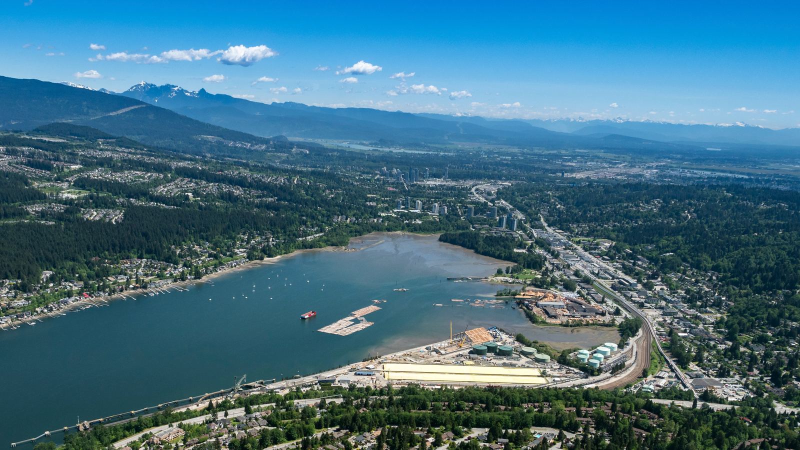 Aerial view of Port Moody's shoreline, rail corridor, and residential streets